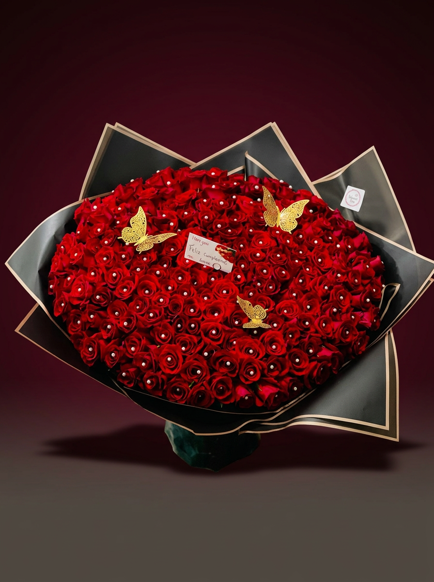 Oversized red rose bouquet wrapped in black and gold paper with gold butterflies