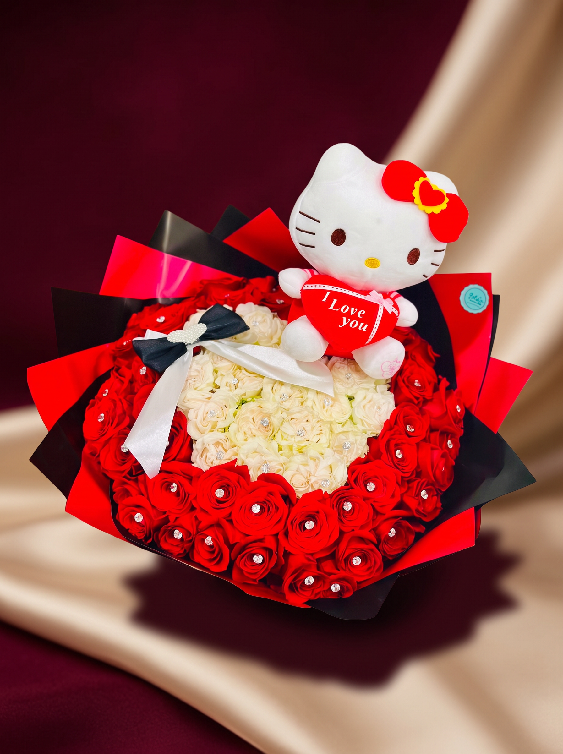 Heart bouquet of red and white roses with a plush kitty