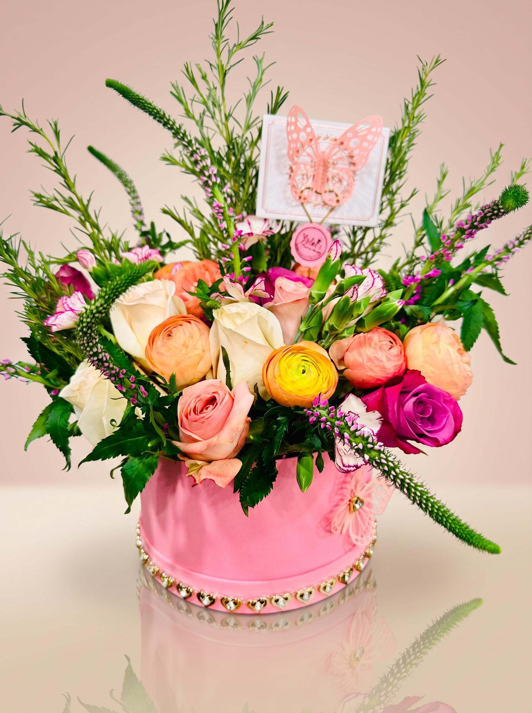 Pink hatbox arrangement with garden roses and ranunculus